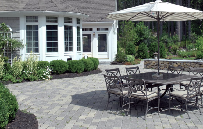 An attractive back patio with a grey paver stone floor