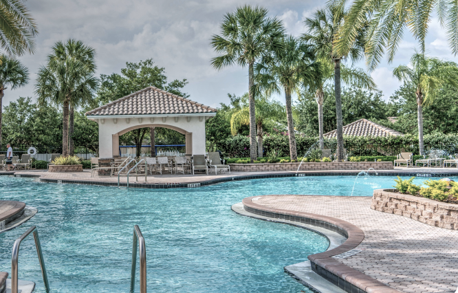 A paver stone pool deck surrounding a large pool