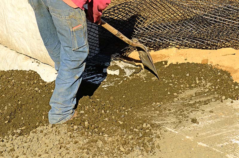 A concrete worker filling a sinkhole