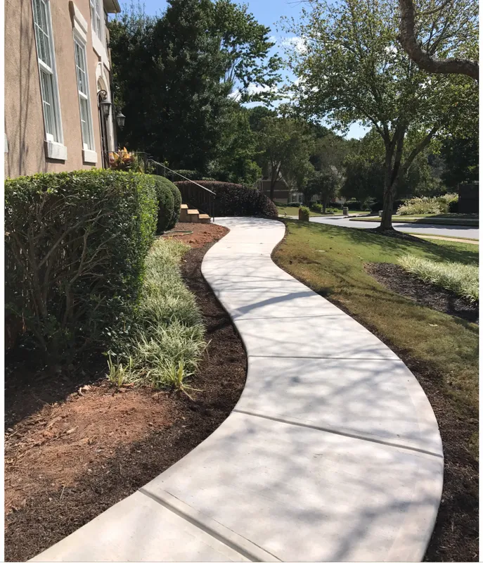 A segmented concrete walkway leading up to the front of a home